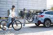 An image of cyclists loading bikes on the Thule OutWay Hanging 2