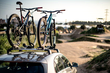 An image of bikes fitted to a Thule ProRide next to a bike park